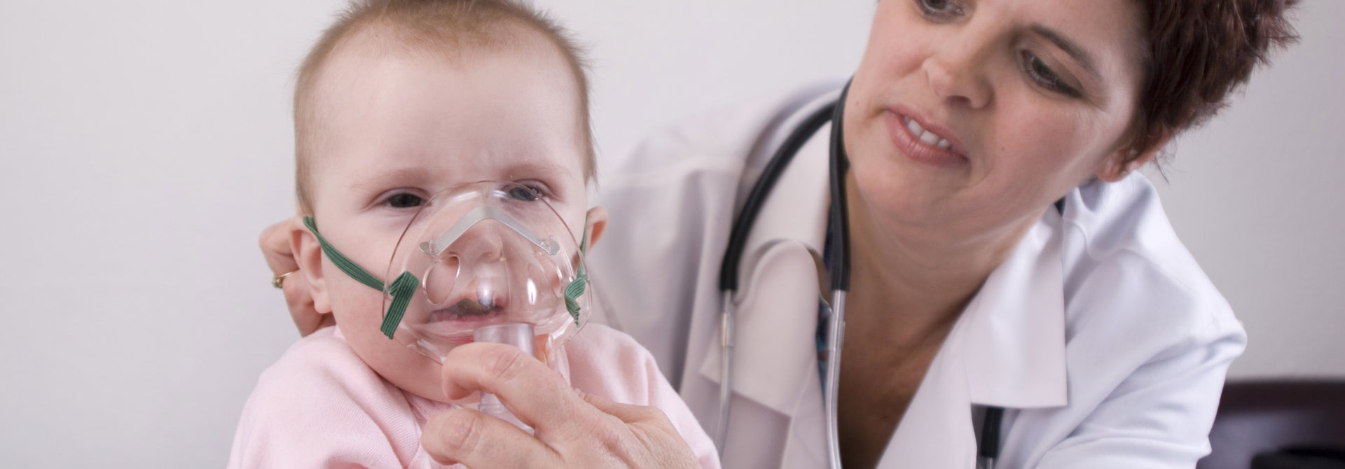 doctor giving baby a nebulizer